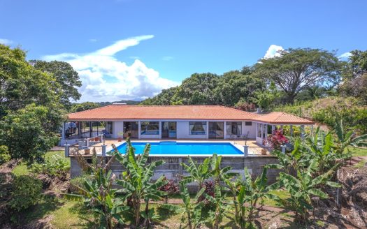 In gated community close to town with large pool and land